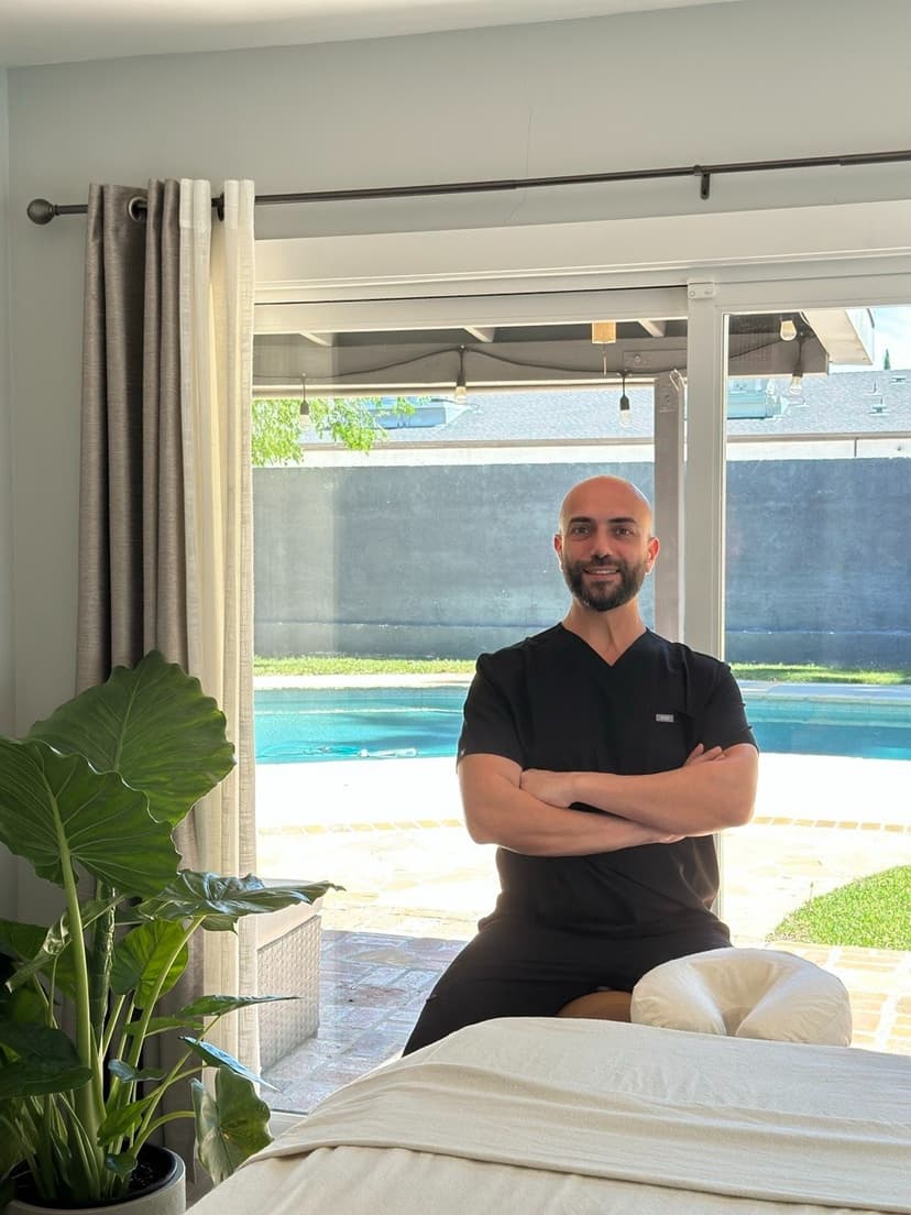 Zorik in his studio in black scrubs